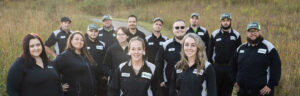 A group photo of the Pest Pros team in uniform.