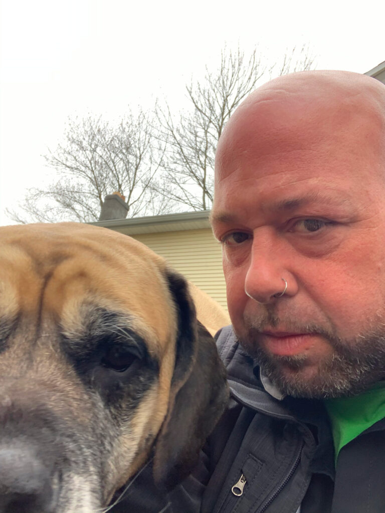 One of our Pest Pros technicians posing side by side with his dog, symbolizing the pet-friendly approach to pest control.